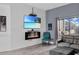 Modern living room with electric fireplace and large TV at 9051 Treasure Trove Ln # 301, Kissimmee, FL 34747