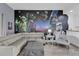 Living room boasts a Star Wars mural and comfy sectional sofa at 9051 Treasure Trove Ln # 301, Kissimmee, FL 34747