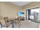 Outdoor patio with table, chairs, and large screen TV at 9051 Treasure Trove Ln # 301, Kissimmee, FL 34747
