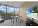 Screened balcony with table, chairs, and large TV at 9051 Treasure Trove Ln # 301, Kissimmee, FL 34747
