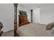 Main bedroom with a four-poster bed and armoire at 9331 Revere Ave, Leesburg, FL 34788