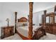 Elegant bedroom with a four-poster bed and ornate furniture at 9331 Revere Ave, Leesburg, FL 34788