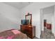 Bright bedroom with wood dresser and TV at 9331 Revere Ave, Leesburg, FL 34788