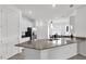 Modern kitchen with an island, stainless steel appliances, and white cabinets at 9331 Revere Ave, Leesburg, FL 34788