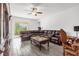Relaxing living room with sectional sofa and large TV at 9331 Revere Ave, Leesburg, FL 34788