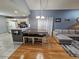 Kitchen island with seating, adjacent to living room and kitchen at 1062 Gwyn Cir, Oviedo, FL 32765