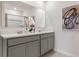 Modern double vanity bathroom with gray cabinets and a large mirror at 1253 Limbali St, Mount Dora, FL 32757