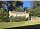 The detached garage is nicely landscaped with green grass and decorative shrubs, enhancing the property's appeal at 127 W Palmetto Ave, Deland, FL 32720