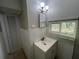 Bathroom featuring sink, medicine cabinet, vanity lights, window and access to linen closet at 127 W Palmetto Ave, Deland, FL 32720
