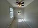 Simple bedroom with tile floors and a window at 127 W Palmetto Ave, Deland, FL 32720