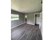 A gray bedroom features wood-look floors, a window, and a closet, creating a cozy atmosphere at 127 W Palmetto Ave, Deland, FL 32720