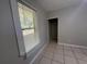 Bedroom with tile floors, window with blinds, and closet with room for storage at 127 W Palmetto Ave, Deland, FL 32720