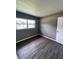 Bright bedroom with wood-look floors and large windows at 127 W Palmetto Ave, Deland, FL 32720
