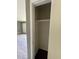 A small, empty closet featuring a single shelf and dark flooring, ready for storage solutions at 127 W Palmetto Ave, Deland, FL 32720
