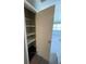 An open closet with shelves provides ample storage space in this well-lit room at 127 W Palmetto Ave, Deland, FL 32720