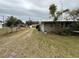 A yard view displays a driveway next to a home with a metal roof, offering functionality and curb appeal at 127 W Palmetto Ave, Deland, FL 32720