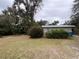 This home showcases a well-maintained yard with lush greenery, complemented by fresh paint and a durable metal roof at 127 W Palmetto Ave, Deland, FL 32720