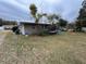 Tan house with side yard and hammock at 127 W Palmetto Ave, Deland, FL 32720