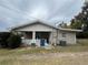 Tan house with front yard and ac unit at 127 W Palmetto Ave, Deland, FL 32720