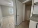 View of a bedroom with tiled floors and a window at 127 W Palmetto Ave, Deland, FL 32720