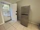 Kitchen area featuring stainless steel refrigerator and exterior access door to the backyard at 127 W Palmetto Ave, Deland, FL 32720