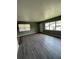 Spacious living room featuring grey walls and wood-look floors at 127 W Palmetto Ave, Deland, FL 32720