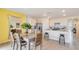 Kitchen and dining area with an island, white cabinets, and gray table at 1280 Hanoverian Dr, Lake Alfred, FL 33850