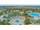 Large community pool complex with various pools, a playground, and lounge areas at 1427 Wexford Way, Davenport, FL 33896