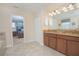 Bathroom with double vanity and a view of the bedroom at 1427 Wexford Way, Davenport, FL 33896
