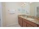 Double vanity bathroom with granite countertops and a large mirror at 1427 Wexford Way, Davenport, FL 33896