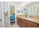 Bathroom with double vanity and access to a bedroom at 1427 Wexford Way, Davenport, FL 33896