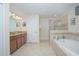 Large bathroom with double vanity and garden tub at 1427 Wexford Way, Davenport, FL 33896