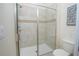 Clean bathroom with a walk-in shower and tile surround at 1427 Wexford Way, Davenport, FL 33896