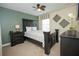 Bedroom with a dark wood bed frame and ceiling fan at 1427 Wexford Way, Davenport, FL 33896