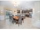 Bright dining room with a large wooden table, chandelier, and sliding doors overlooking the pool at 1427 Wexford Way, Davenport, FL 33896