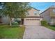 Two-story house with a two-car garage and a brick paved driveway at 1427 Wexford Way, Davenport, FL 33896