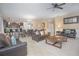 Open living room and kitchen area with tile floors and comfortable seating at 1427 Wexford Way, Davenport, FL 33896