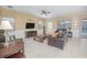 Spacious living room with leather sofas, a large TV, and tile floors at 1427 Wexford Way, Davenport, FL 33896