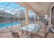 Outdoor patio area with a table and chairs overlooking the pool at 1427 Wexford Way, Davenport, FL 33896