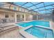 Relaxing screened pool and spa with lounge chairs for sunbathing at 1427 Wexford Way, Davenport, FL 33896
