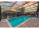 Enjoy the large pool, hot tub, and mounted TV under a screened-in lanai, perfect for outdoor entertainment and relaxation at 1427 Wexford Way, Davenport, FL 33896