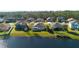 Aerial view showcasing lakefront property with mature trees and neighboring homes at 164 Pergola Pl, Ormond Beach, FL 32174