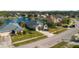 Aerial view of homes in a quiet suburban neighborhood with a serene lake and fountain at 164 Pergola Pl, Ormond Beach, FL 32174