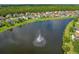 Aerial view of the community lake, featuring a central fountain at 164 Pergola Pl, Ormond Beach, FL 32174