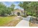 Exterior view of the community clubhouse featuring desert landscaping and a paved walkway at 164 Pergola Pl, Ormond Beach, FL 32174