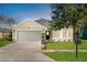Charming single-story home features a manicured lawn, two car garage, and covered entry at 164 Pergola Pl, Ormond Beach, FL 32174