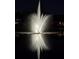 Night shot of a lit fountain with light reflected in the water at 164 Pergola Pl, Ormond Beach, FL 32174