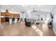 Open-concept living room with a kitchen island, tile flooring, and large windows offering ample natural light at 164 Pergola Pl, Ormond Beach, FL 32174