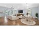 Bright and airy living room featuring tile floors, vaulted ceilings, and a dining area at 164 Pergola Pl, Ormond Beach, FL 32174