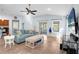 Bright living room featuring vaulted ceilings, tile flooring, and sliding door access to the lanai at 164 Pergola Pl, Ormond Beach, FL 32174